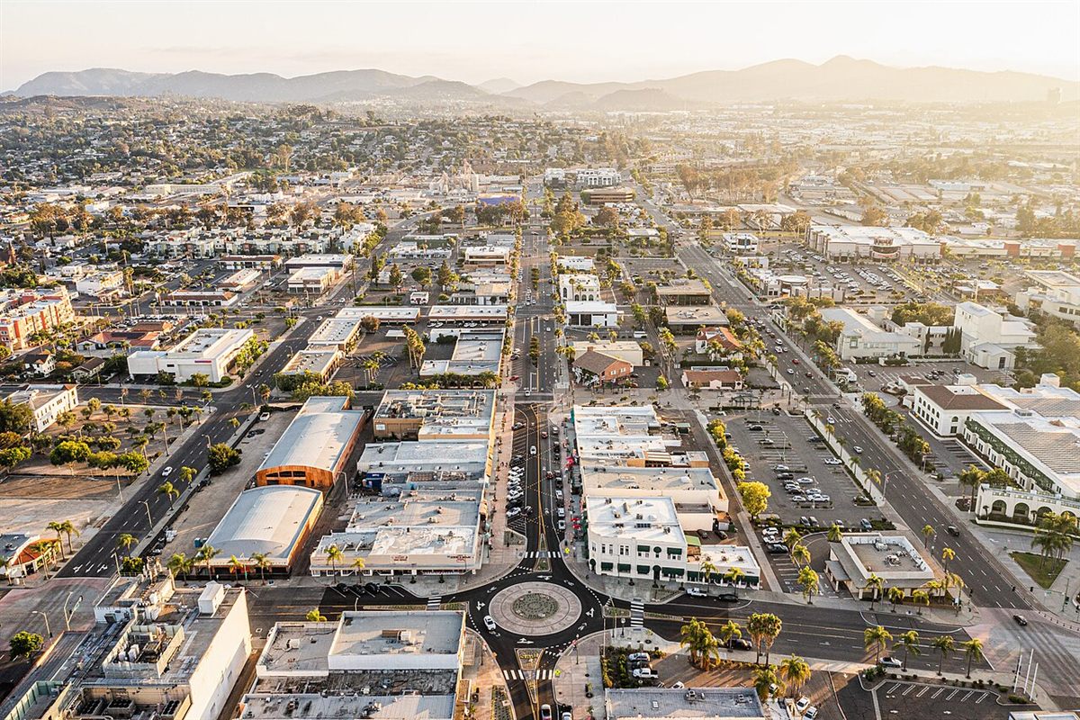 Aerial view of downtown Escondido, California at golden hour with mountains in the background