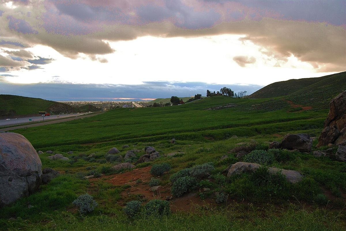 Green Jurupa Mountains landscape with residential areas in western Riverside County, California