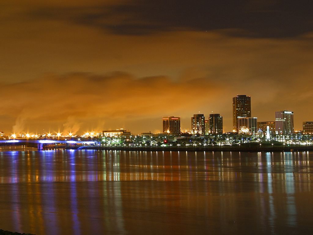 Long Beach city skyline at night reflected in the harbor, California
